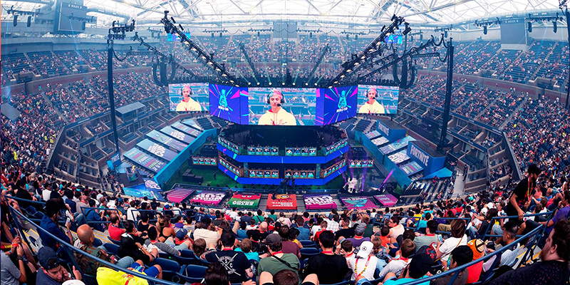 Esports team competing in a packed arena during a tournament.