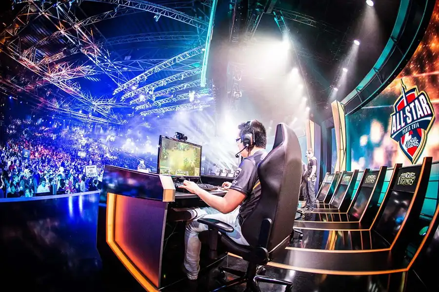 An image of a man competing with opponents at an ESports Event.