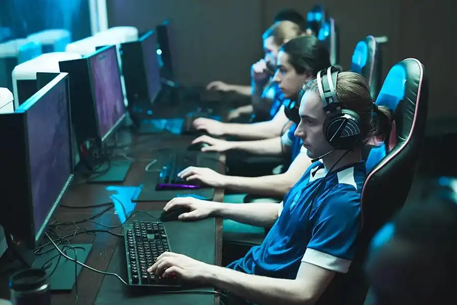 Different players who are competing with others using gaming computers.