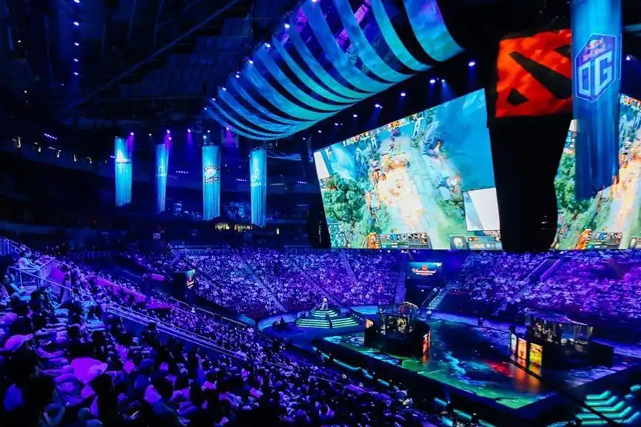 A bustling Dota 2 tournament with a huge crowd in attendance.