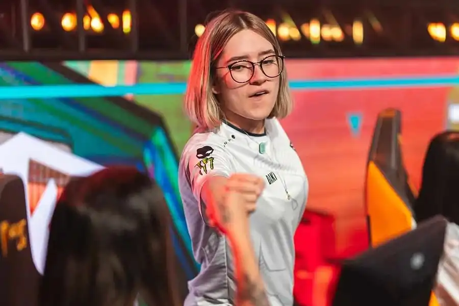 an esports player fist-bumping her teammate.