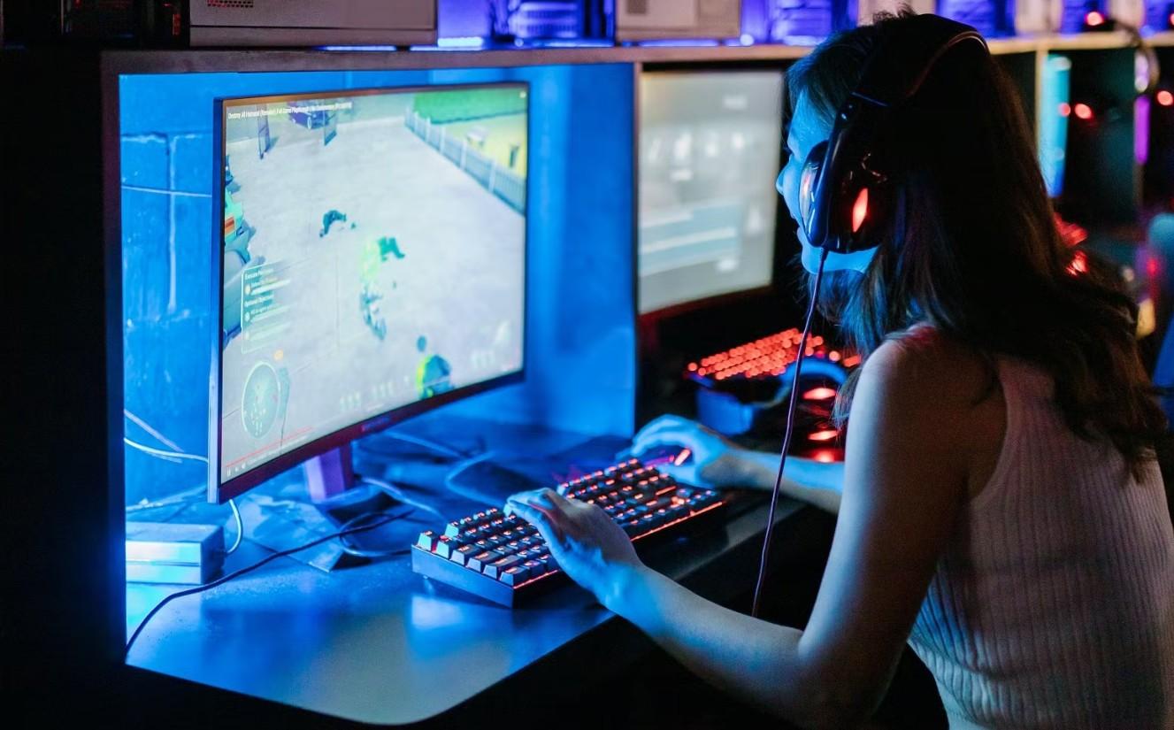 a picture of a female gamer behind her gaming computer.