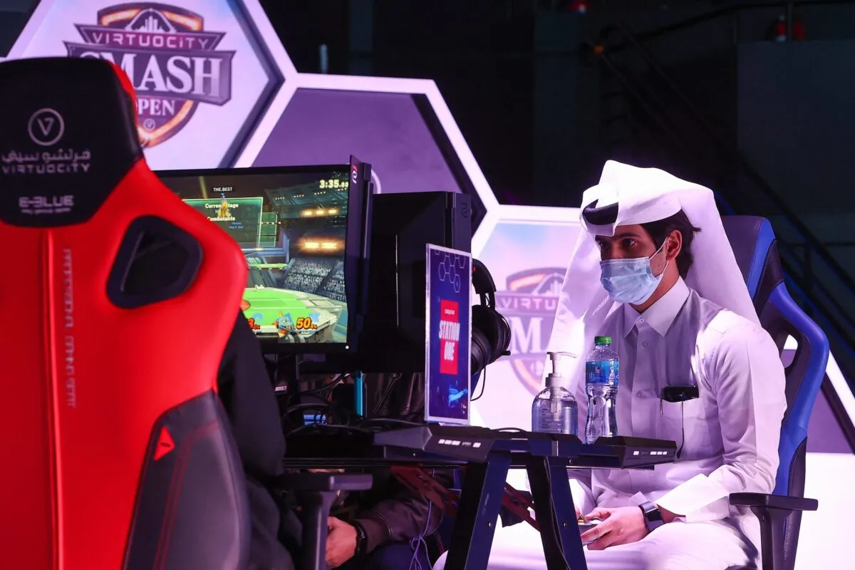 a picture of an Arabian gamer playing video games.