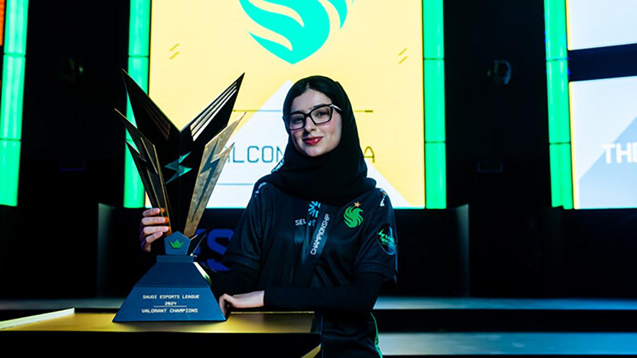 a picture of a female gamer with a trophy.