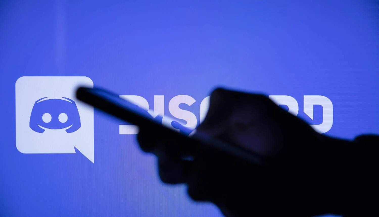 an image of a hand with the Discord logo and name in the background.