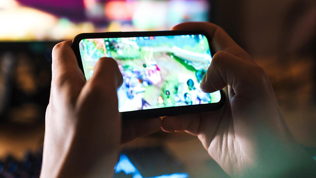 a gamer playing video games with a smartphone.