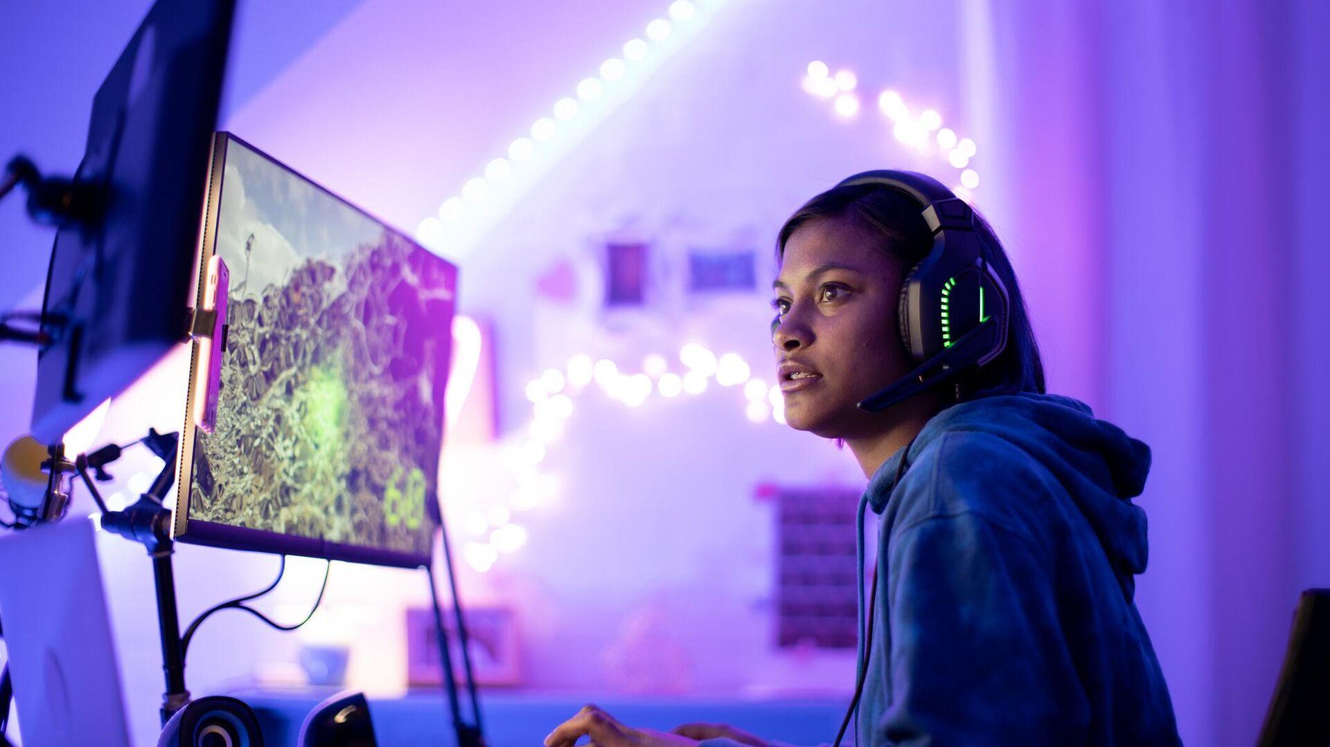 a picture of a female player behind her high-tech computer.