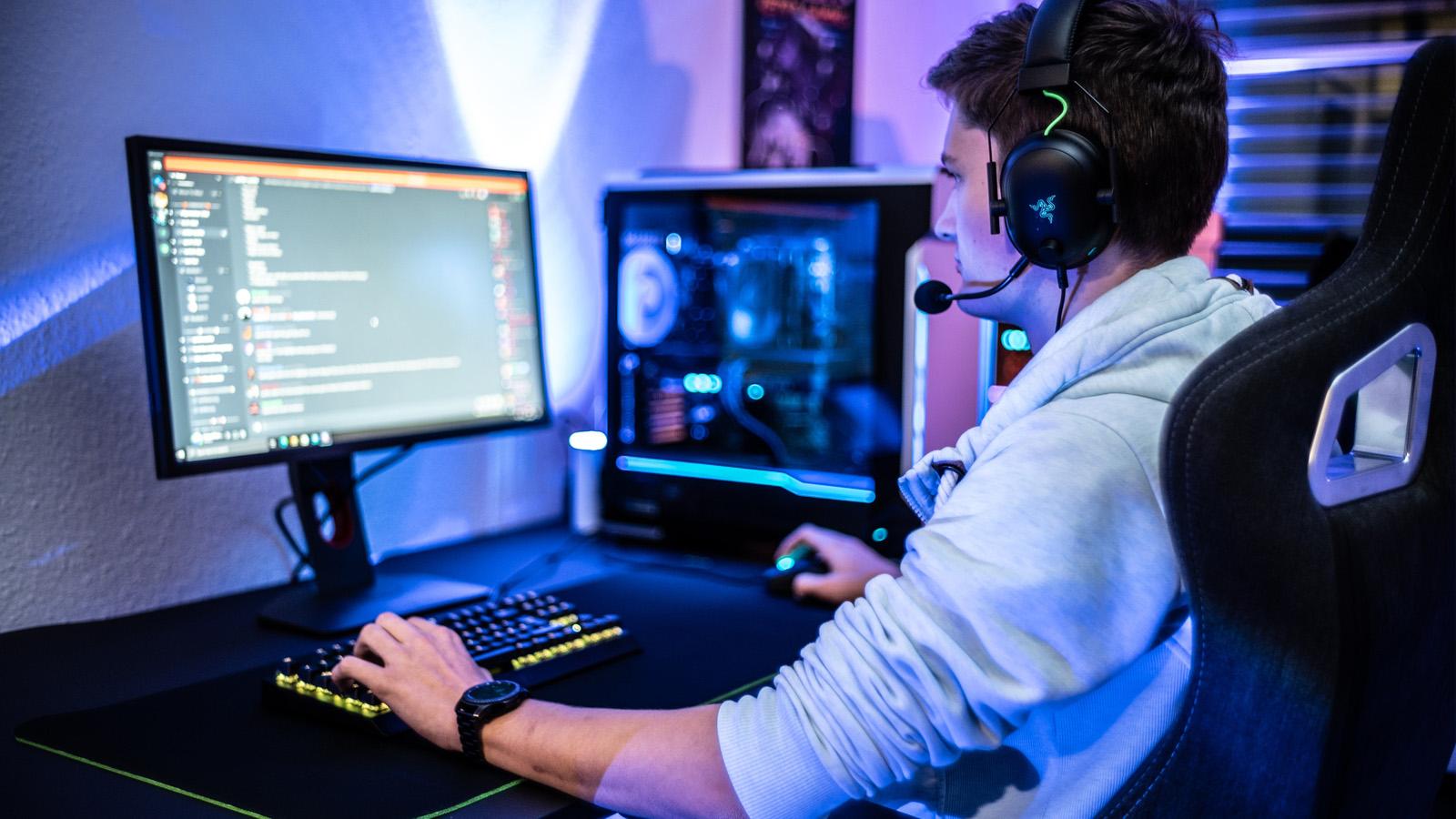 a picture of a player behind his personal computer.