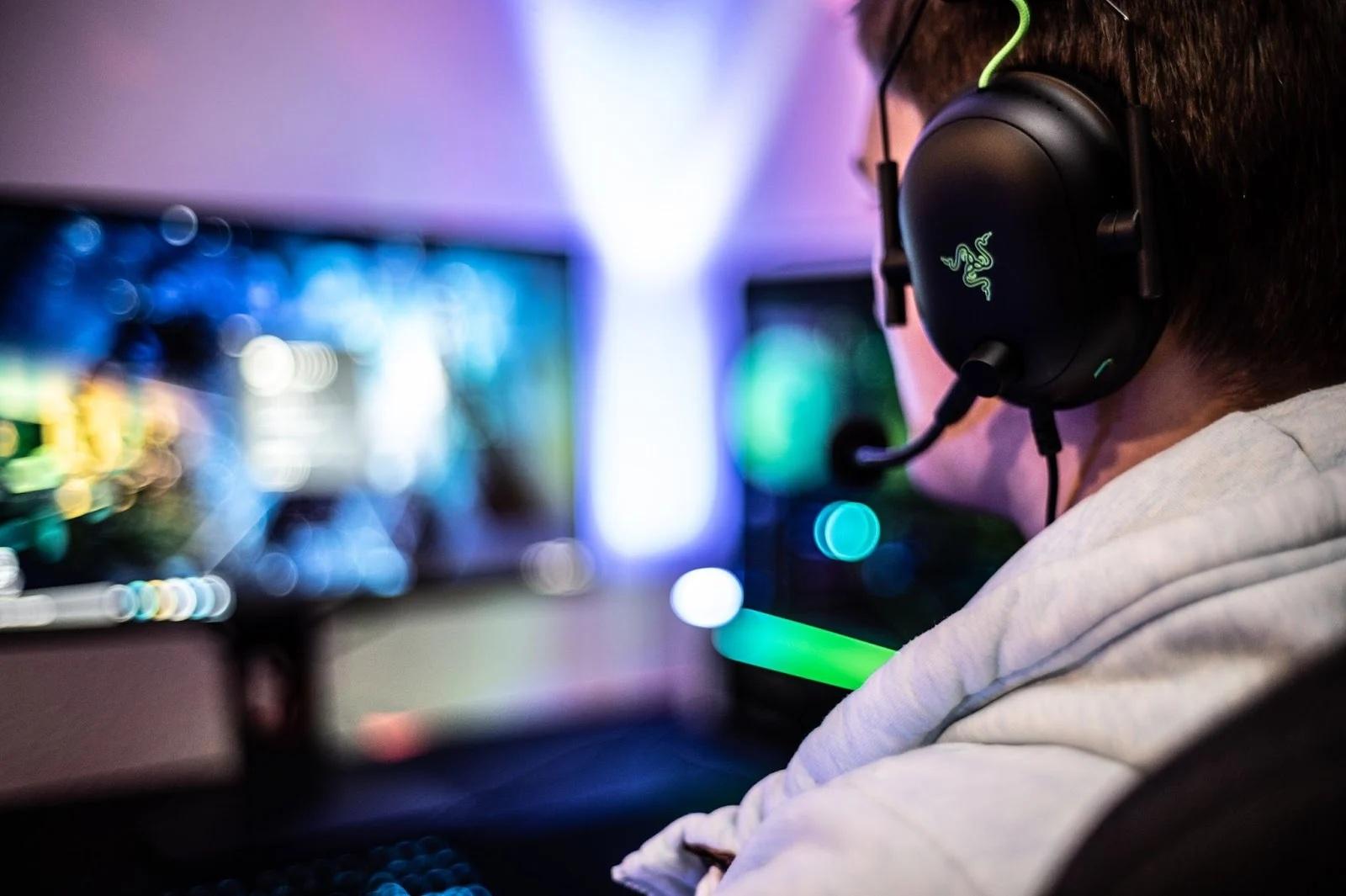 an image of a Player behind his Gaming Computer.