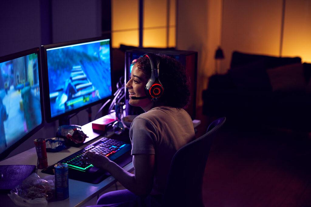 picture of a female player happily playing video games