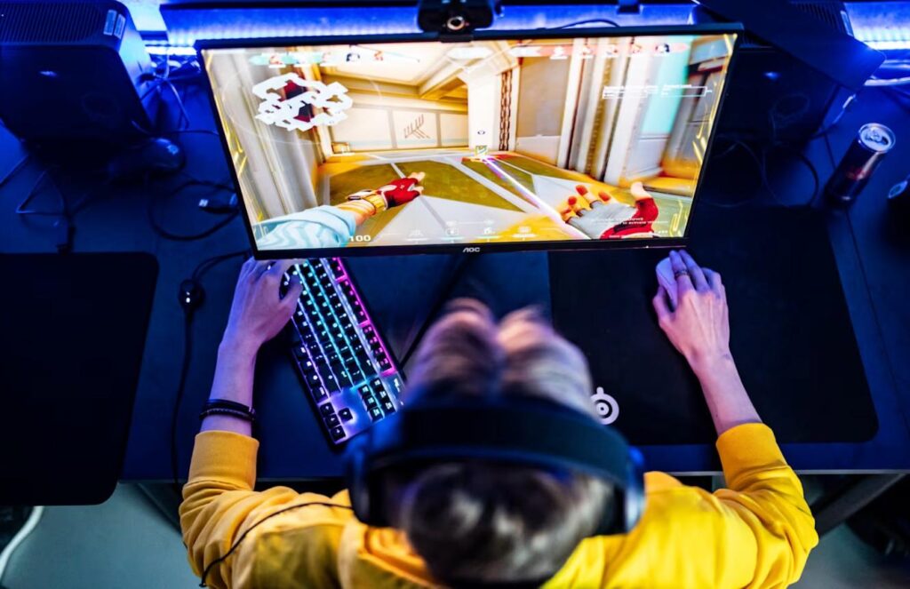 an image of a player sitting behind his gaming computer