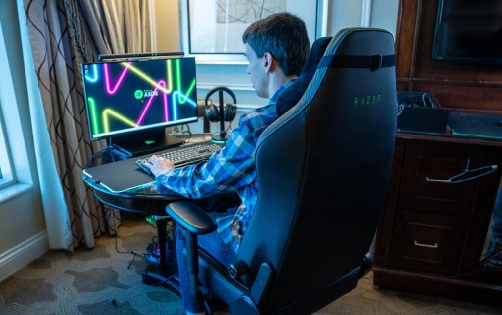This is a picture of a gamer sitting on a gaming chair