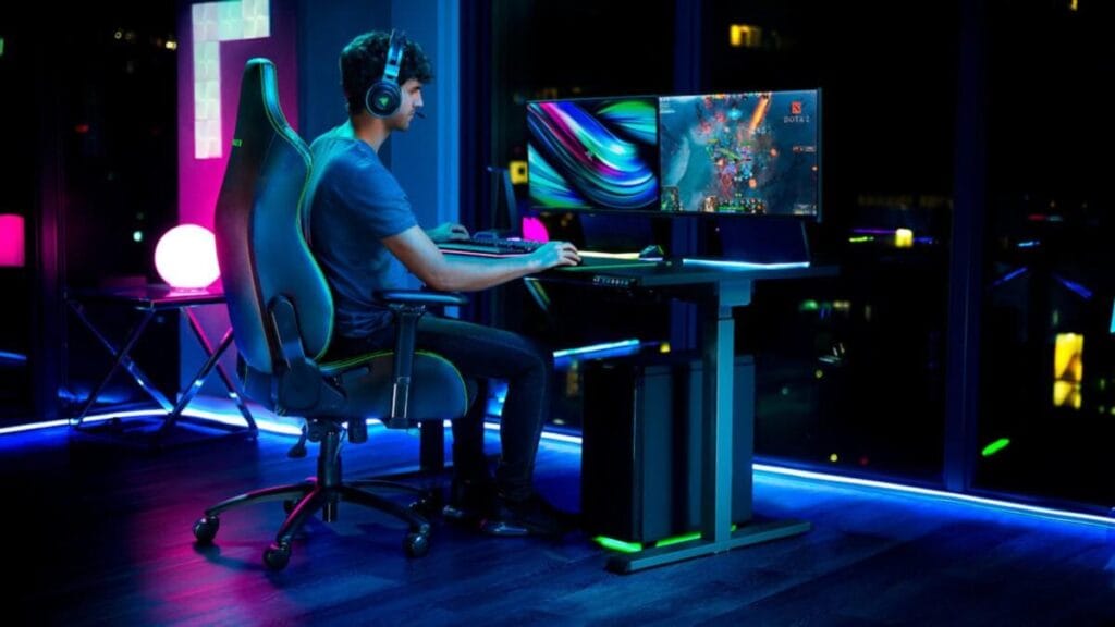 A picture of a gaming room and a player sitting on a gaming chair