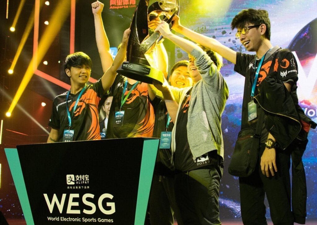 a picture of the TNC Predator ESports Team with a trophy