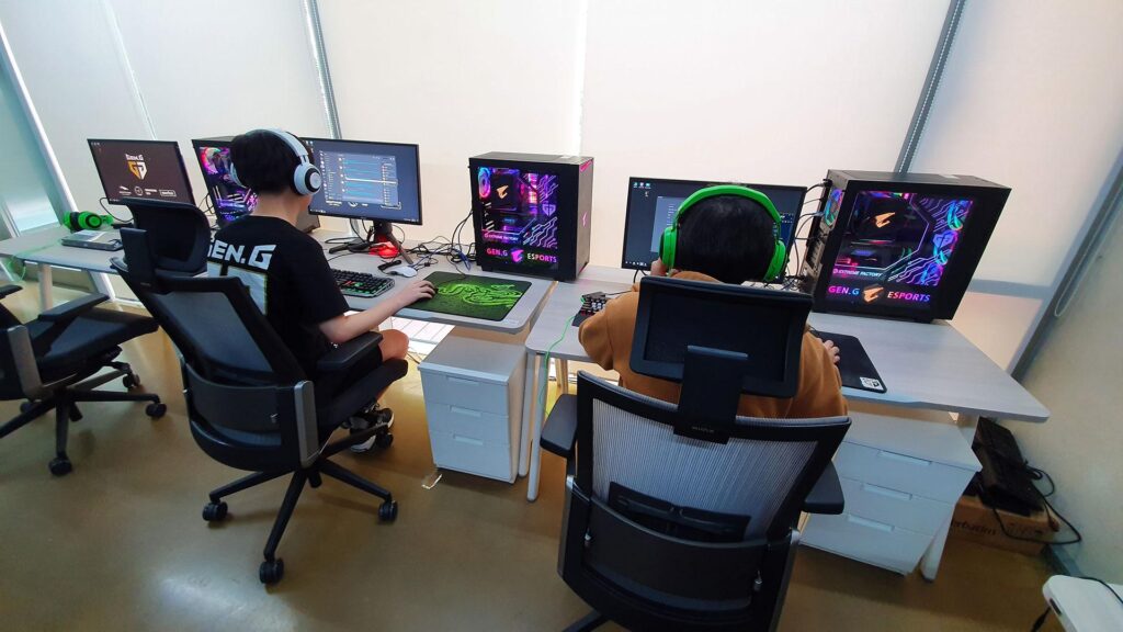 an image of two players behind their gaming computers