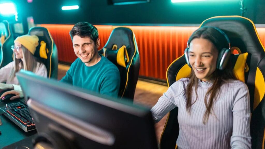 an image of players happily playing behind their computers