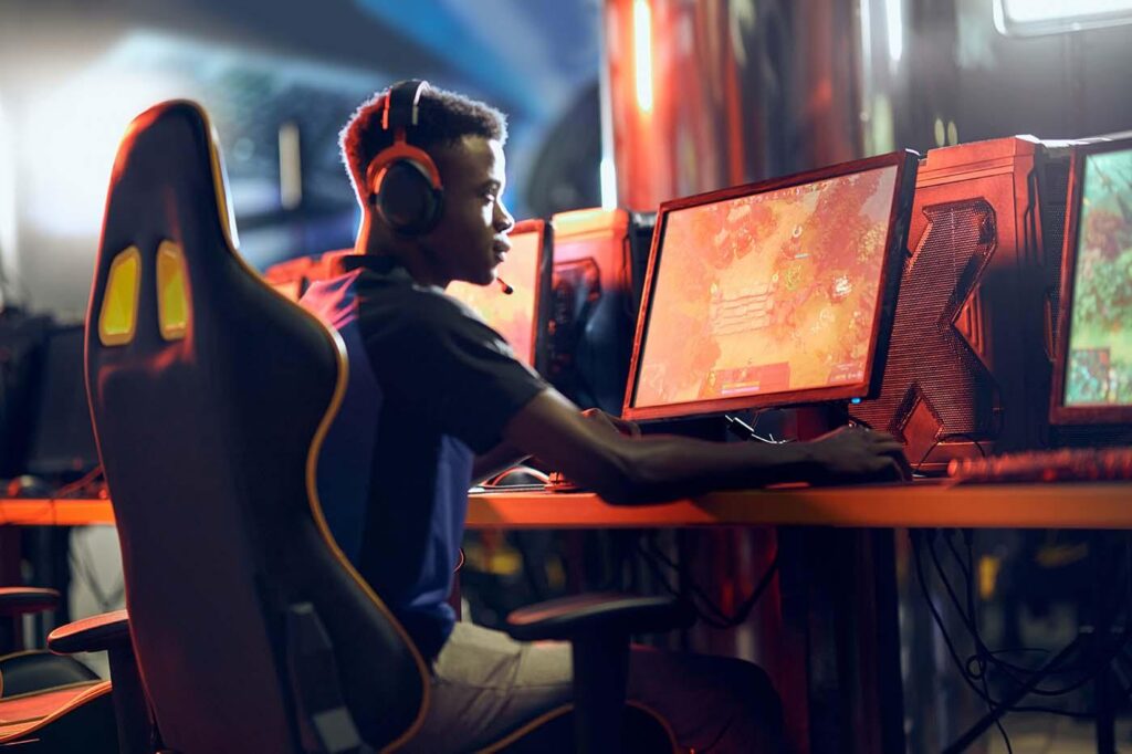 an image of a player behind his gaming computer