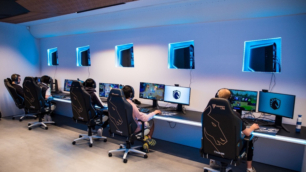 an image of a group of an ESports team playing video games in a pro gaming room