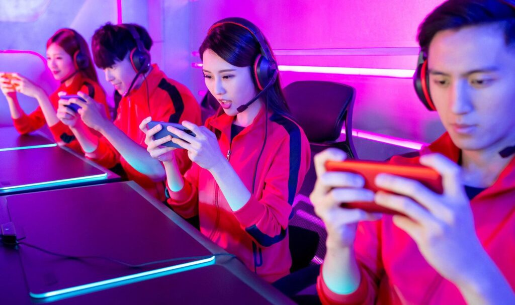 a picture of an ESports Team all competing with their smartphones
